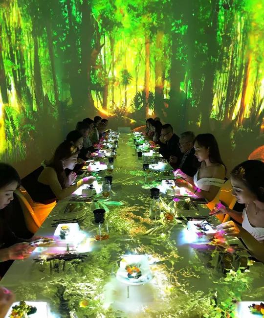 CRAVE 4D dining installation with forest imagery across walls and tables