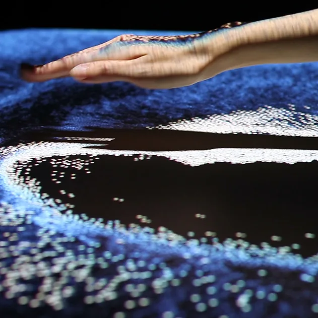 Hand interacting with a projected table display